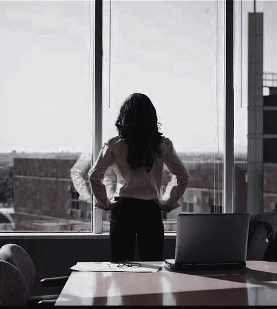 A woman in quiet reflection by a window